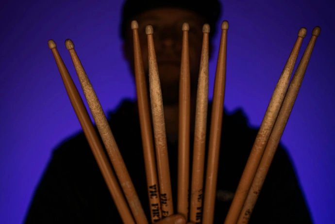 a person holding a group of baseball bats